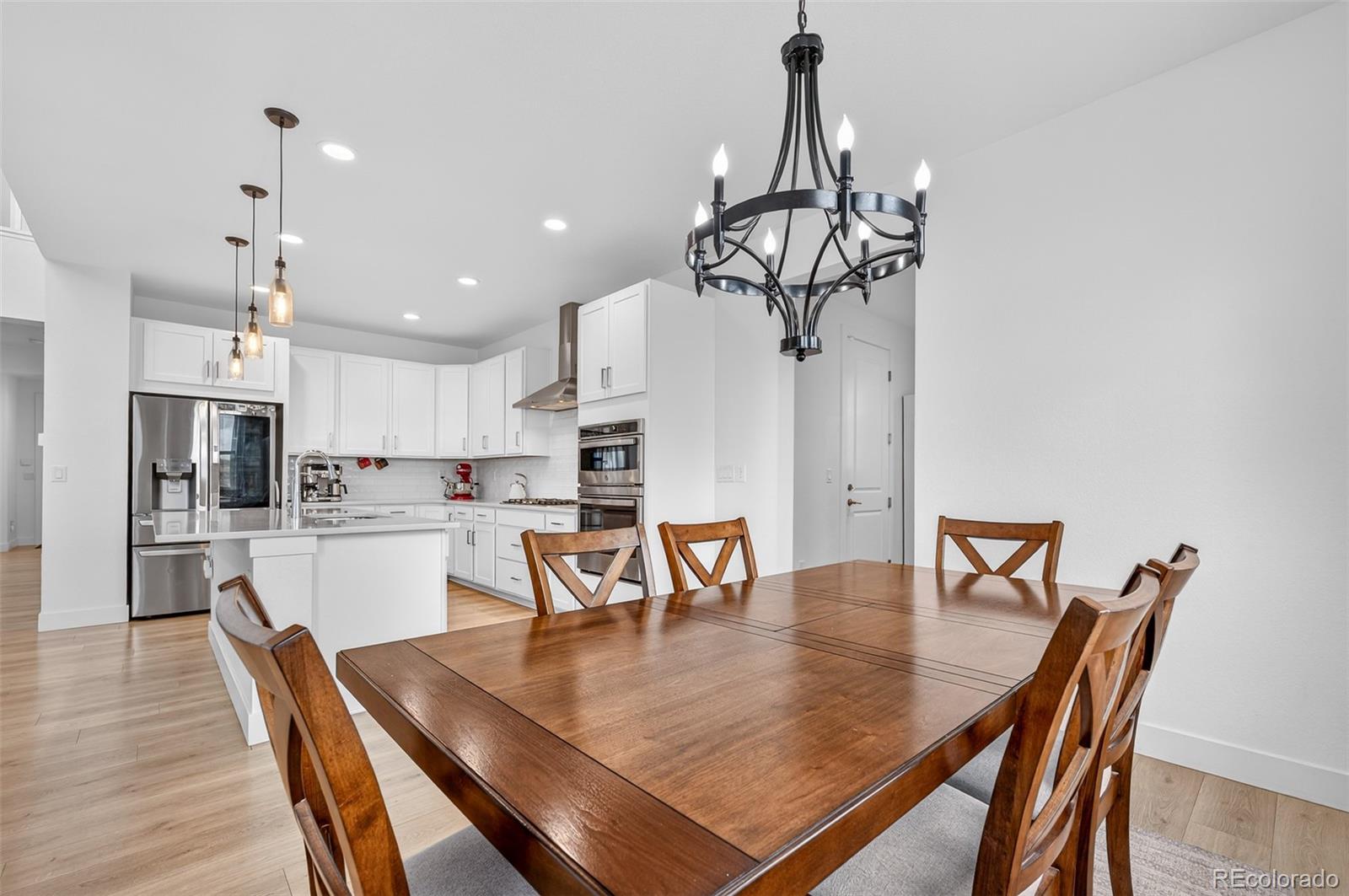 3649 Rucksack Court Castle Rock, CO 80108 - Photo 16 of 48 a view of a dining room with furniture and wooden floor