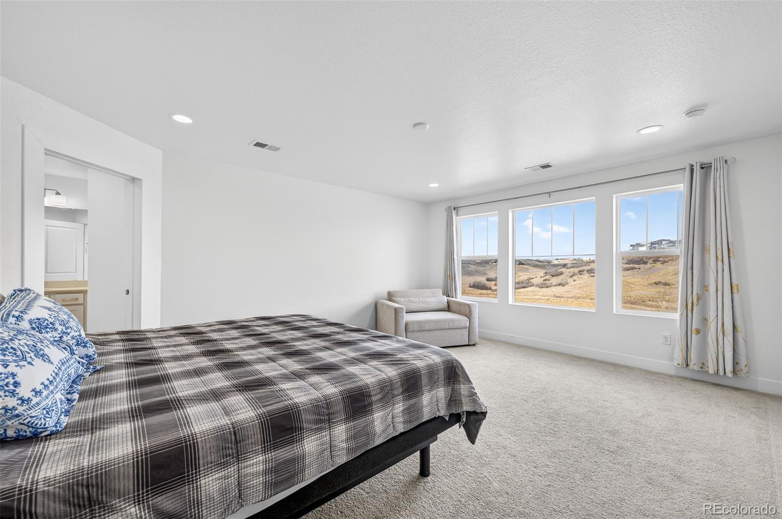 3649 Rucksack Court Castle Rock, CO 80108 - Photo 25 of 48 a spacious bedroom with a large bed and a window