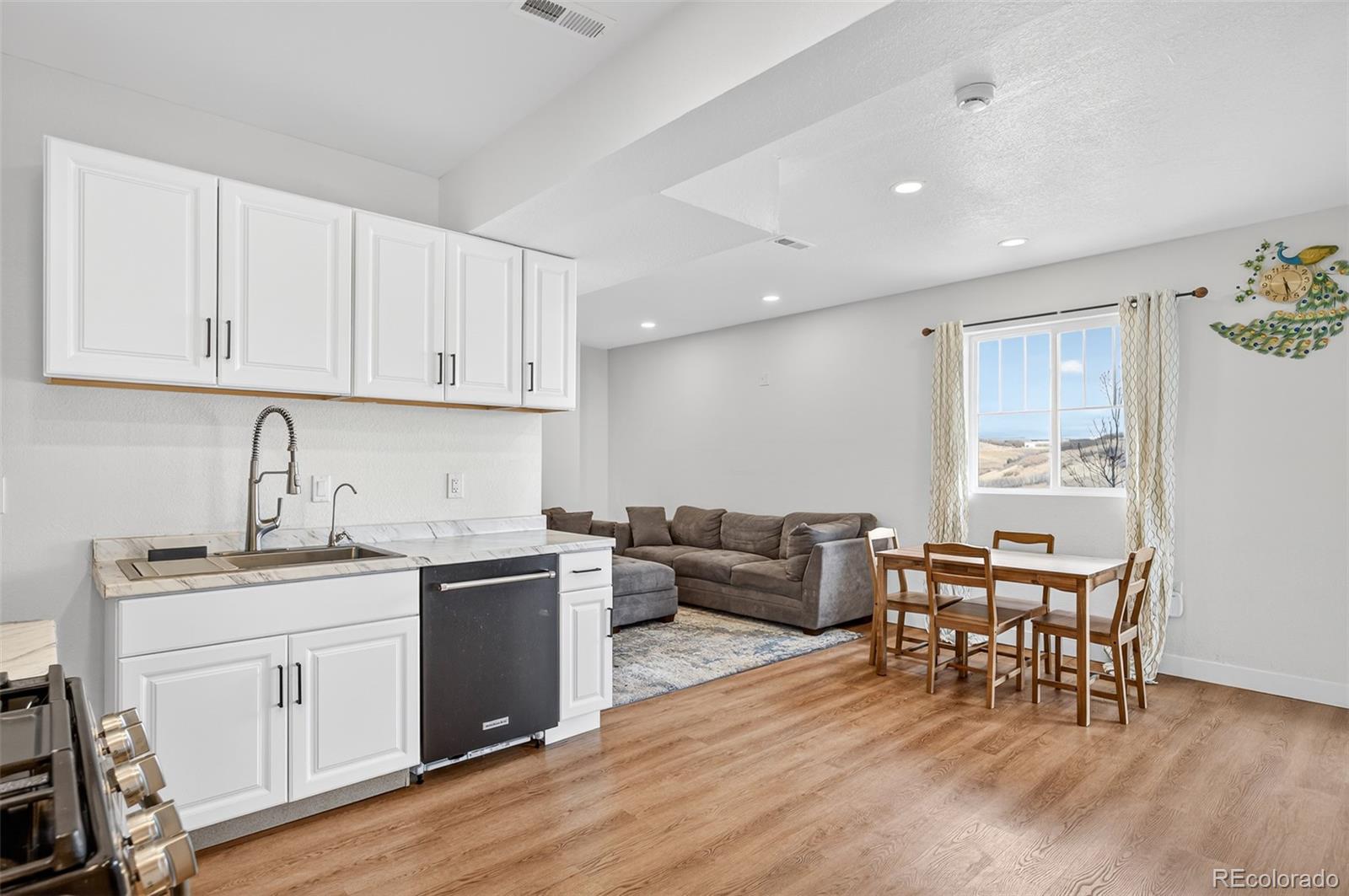 3649 Rucksack Court Castle Rock, CO 80108 - Photo 41 of 48 a kitchen with stainless steel appliances granite countertop a white table chairs and a refrigerator