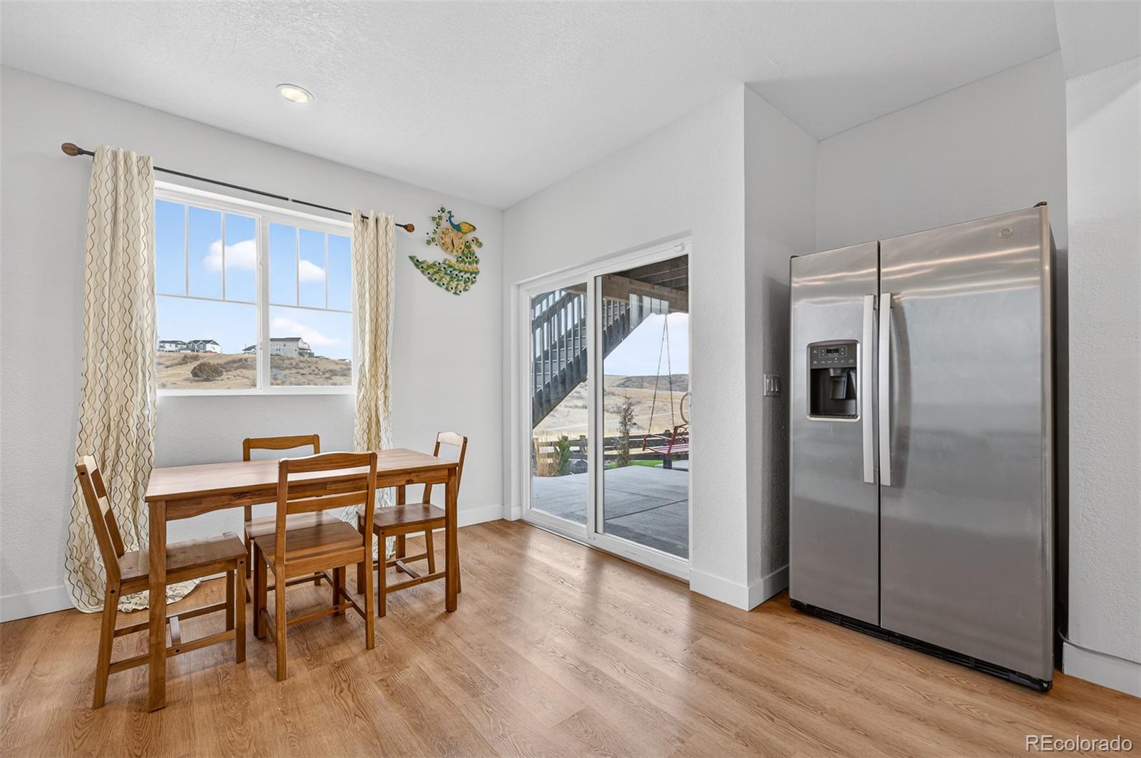 3649 Rucksack Court Castle Rock, CO 80108 - Photo 42 of 48 a view of a dining room with furniture window and wooden floor