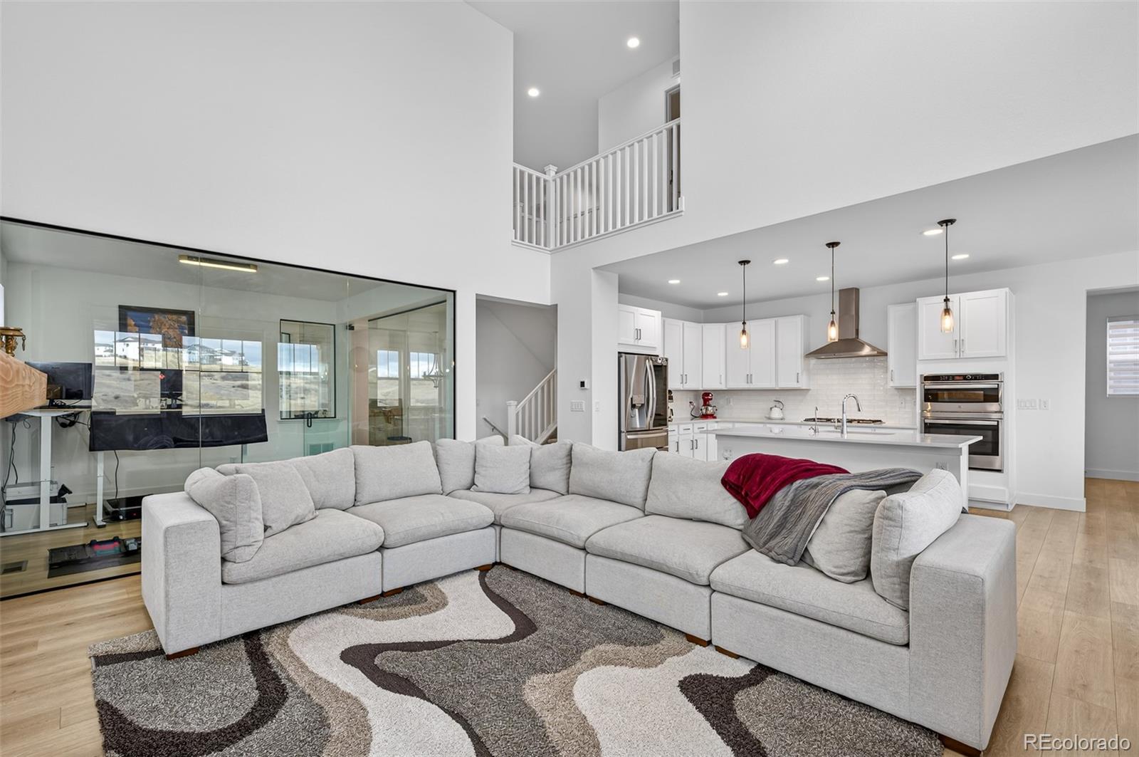 3649 Rucksack Court Castle Rock, CO 80108 - Photo 9 of 48 a living room with furniture white walls and kitchen view