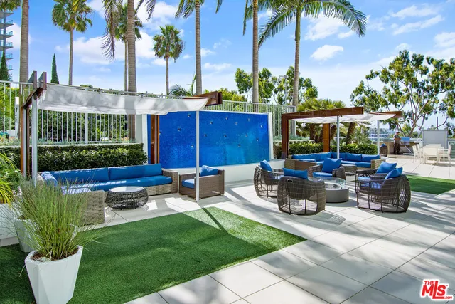 a view of a backyard with sitting area and outdoor kitchen