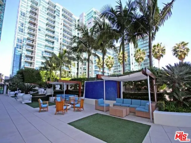 a front view of a house with swimming pool and sitting area