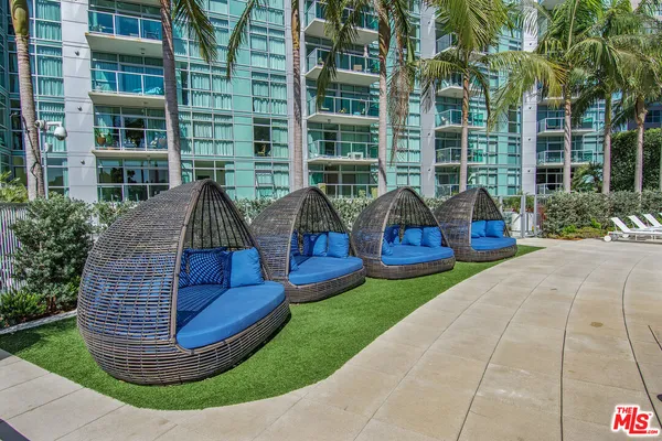 a view of swimming pool with outdoor seating and plants
