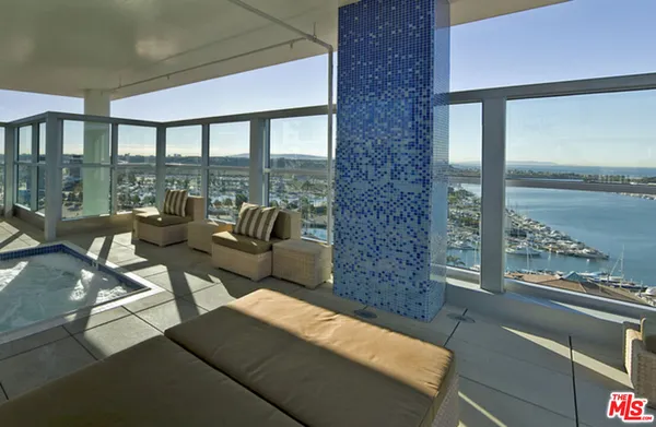 a living room with furniture and floor to ceiling windows