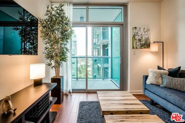 a living room with a couch and a potted plant