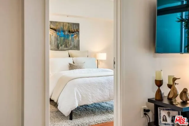 a bedroom with a bed and a mirror