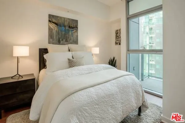 a bedroom with a bed and a night stand