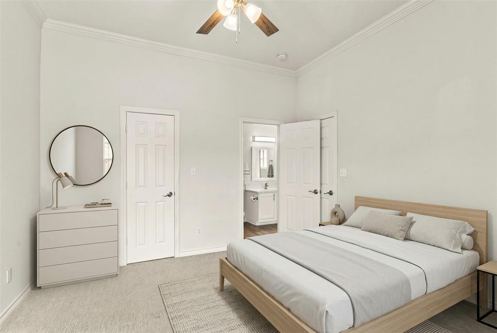 1916 Signal Ridge Place Rockwall, TX 75032 - Photo 17 of 32 Virtually staged Bedroom featuring light carpet, ensuite bathroom, ornamental molding, and ceiling fan