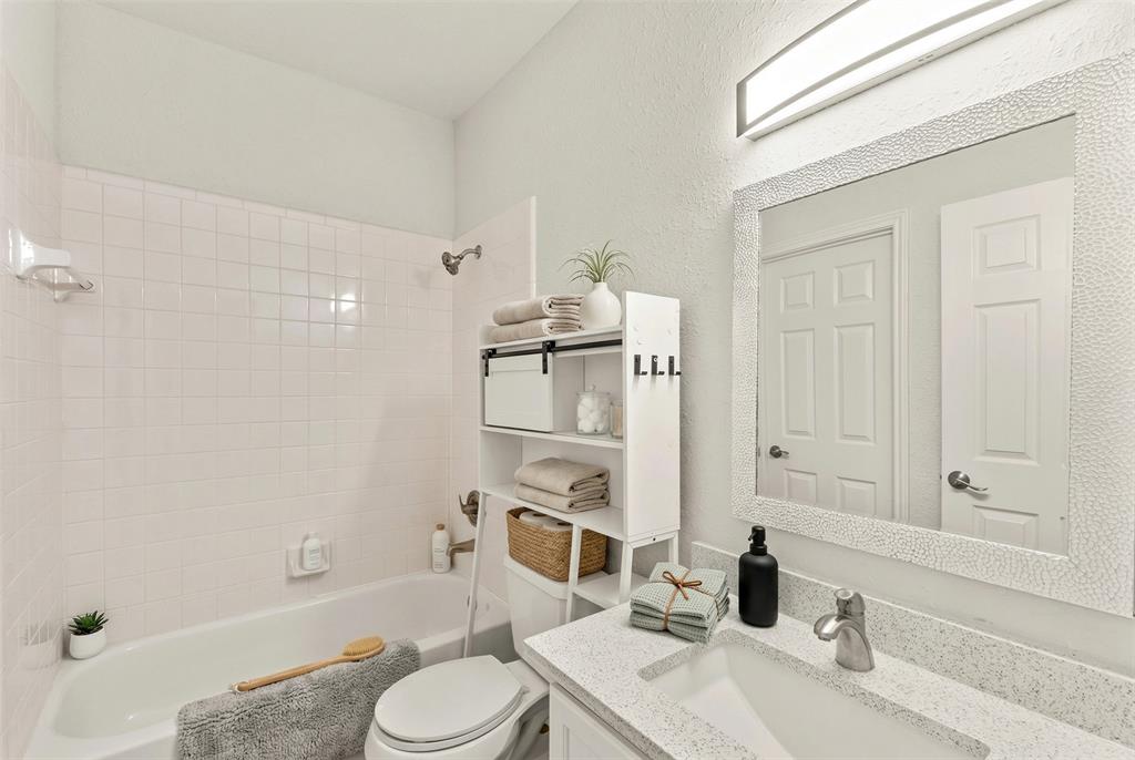 1916 Signal Ridge Place Rockwall, TX 75032 - Photo 18 of 32 Virtually staged Bathroom with vanity, a textured wall, and shower / tub combination