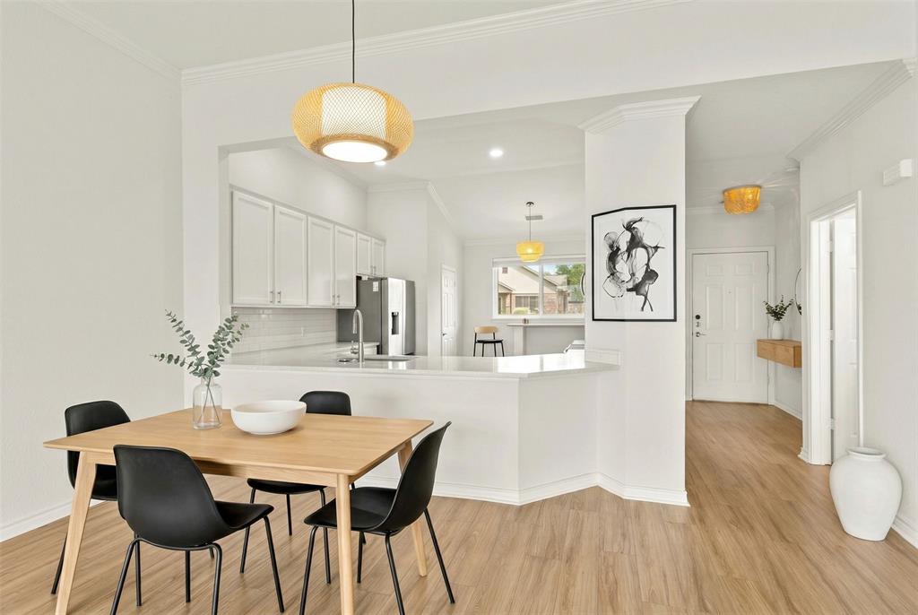 1916 Signal Ridge Place Rockwall, TX 75032 - Photo 4 of 32 Virtually staged Dining space with light wood-style flooring and ornamental molding
