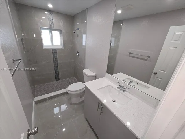 a spacious bathroom with a sink a toilet and shower