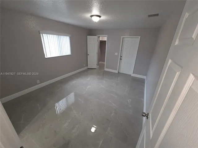 a view of an empty room with a window