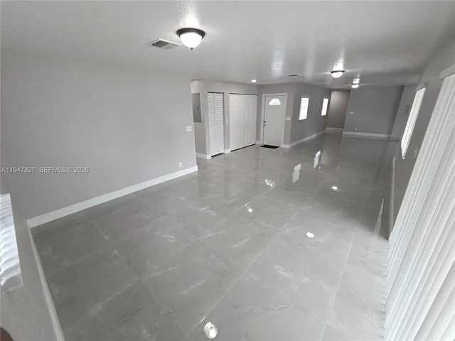 wooden floor in an empty room with a mirror