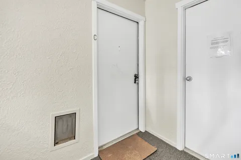a kitchen with stainless steel appliances white cabinets and a wooden floor
