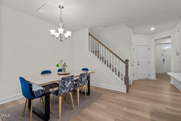 a kitchen with stainless steel appliances granite countertop a stove refrigerator a sink dishwasher with a dining table and chairs