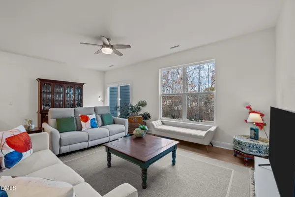 a living room with furniture and kitchen view