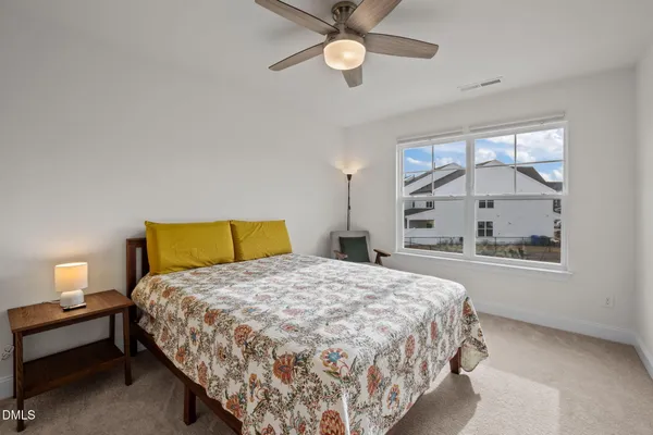 a bedroom with a bed and a couch