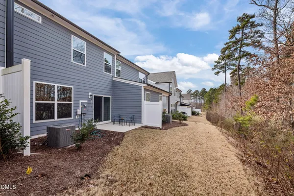 a view of a house with a dry yard and covered with snow