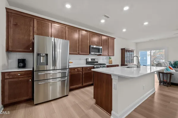 a kitchen with a sink stove and cabinets