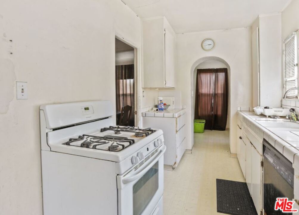 David Avenue Los Angeles, CA 90034 - Photo 12 of 22 a kitchen with stainless steel appliances a stove a sink and a refrigerator