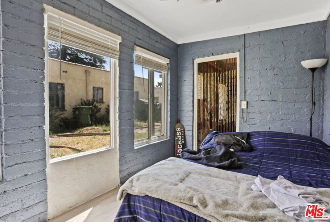 David Avenue Los Angeles, CA 90034 - Photo 17 of 22 a bedroom with a bed and glass door