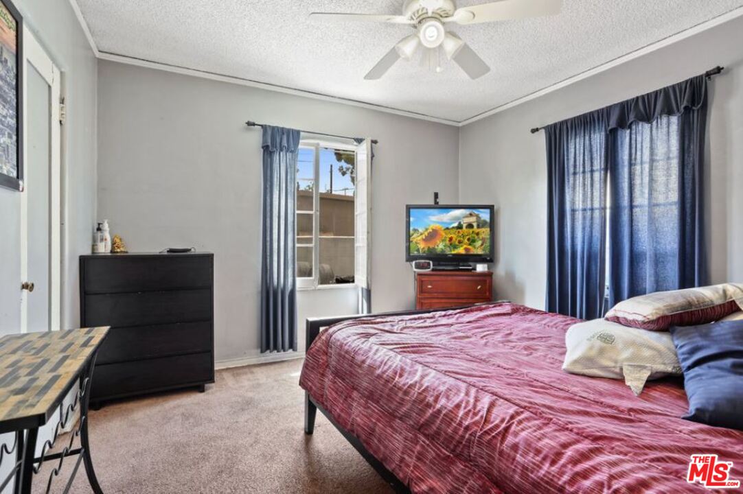 David Avenue Los Angeles, CA 90034 - Photo 9 of 22 a bedroom with a bed and wooden floor