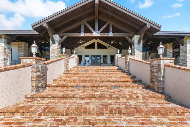 a view of a house with a backyard and a fountain
