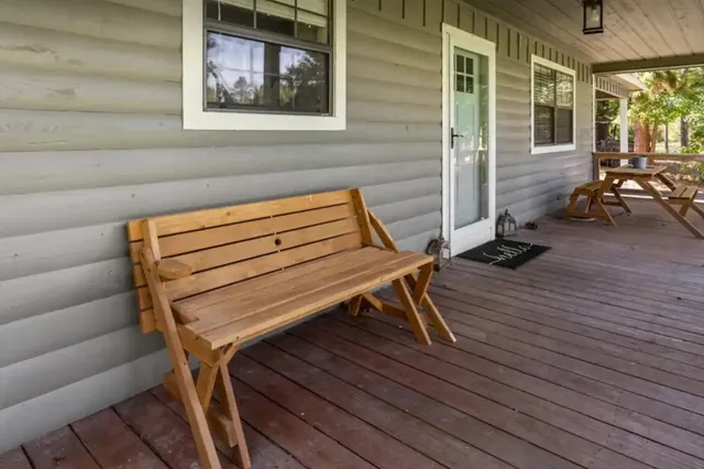 a backyard of a house with barbeque oven table and chairs