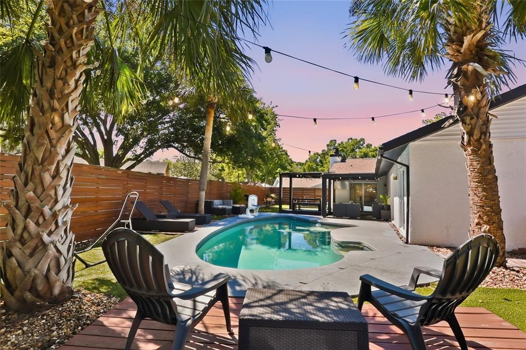 4606 Buckeye Road Tampa, FL 33624 - Photo 5 of 39 a patio with glass top table and chairs