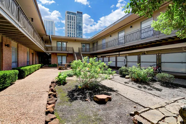a view of a house with a yard and sitting area