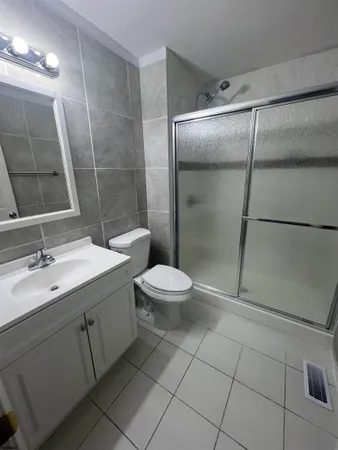 a bathroom with a toilet sink and shower