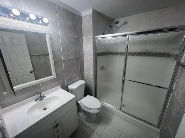 a bathroom with a double vanity sink toilet and shower