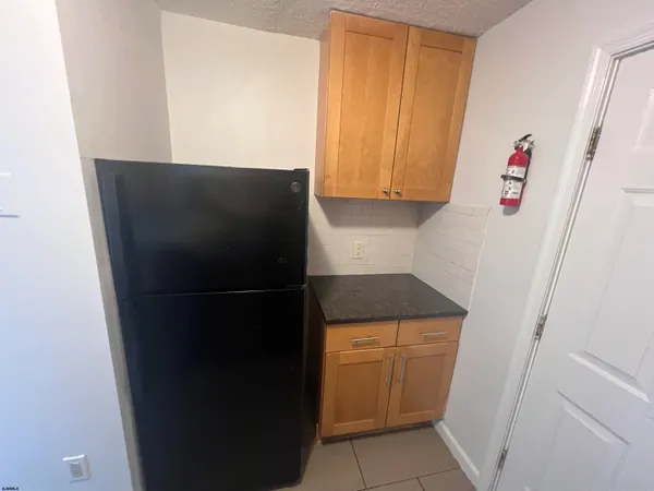 a kitchen with a refrigerator and cabinets