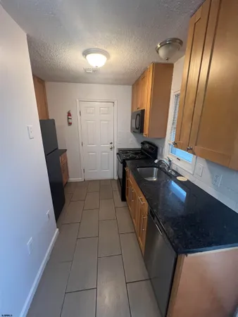 a kitchen with a sink a refrigerator and a stove
