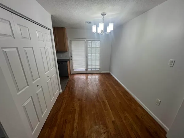 a view of a room with wooden floor and staircase