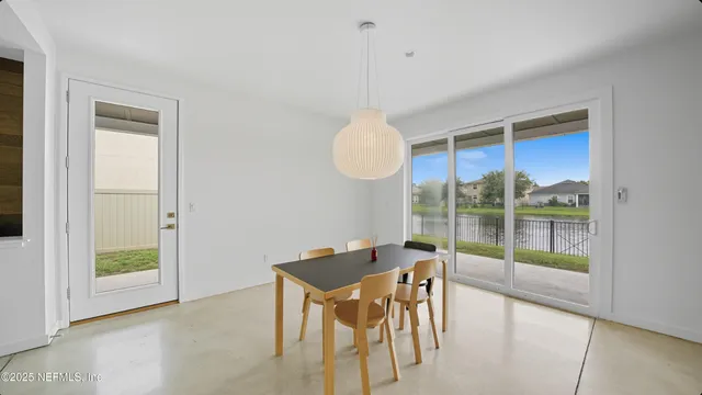 a bedroom with a bed and large window