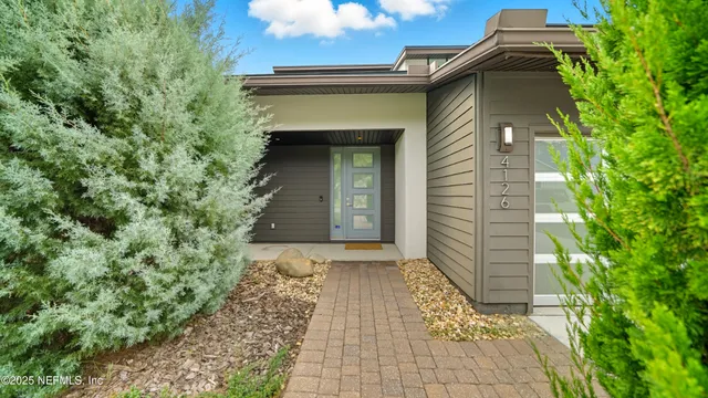 a kitchen with stainless steel appliances a refrigerator a stove a sink and a refrigerator