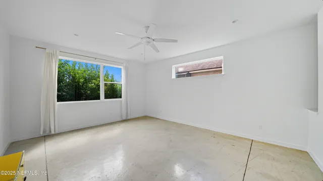 a white toilet sitting next to a white wall