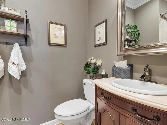 a bathroom with a granite countertop toilet sink and mirror