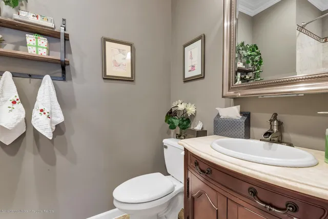 a bathroom with a toilet a sink and mirror