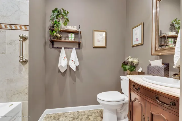 a bathroom with a sink toilet and a mirror