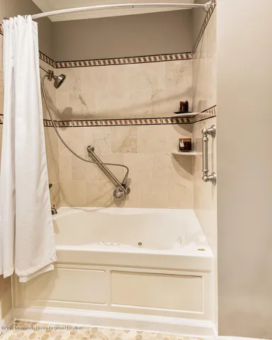 a bathroom with a bathtub and shower