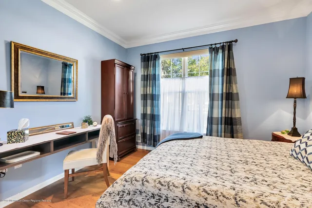 a bedroom with a bed and a desk