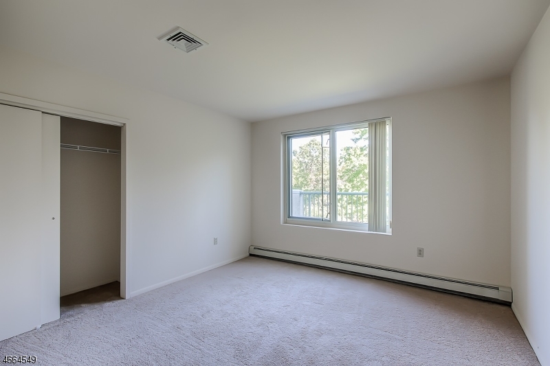 1000 Gates Court, Unit 1047 Morris Plains, NJ 07950 - Photo 14 of 21 an empty room with a window