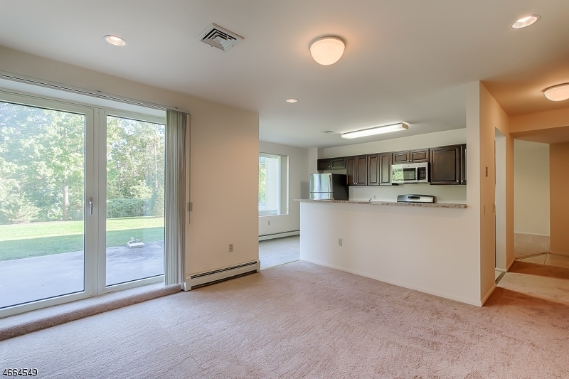 1000 Gates Court, Unit 1047 Morris Plains, NJ 07950 - Photo 3 of 21 a view of a kitchen with refrigerator and window