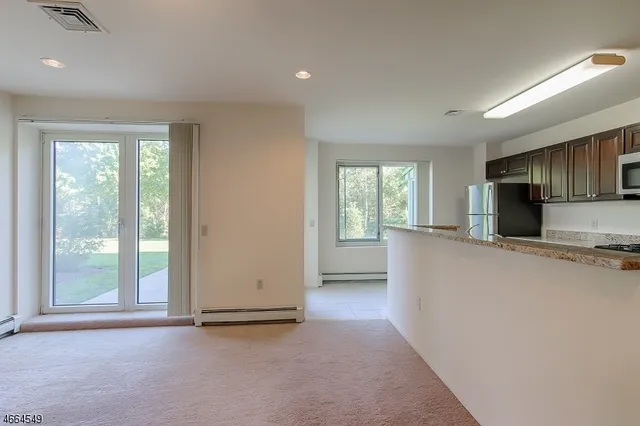 a view of a kitchen with furniture and a window