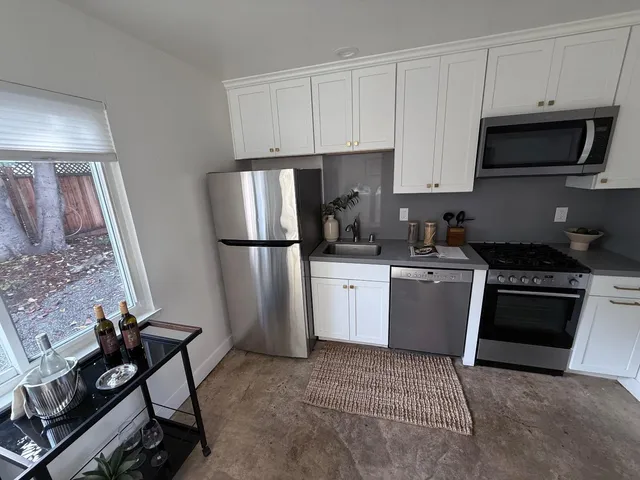 a kitchen with a sink stove and refrigerator