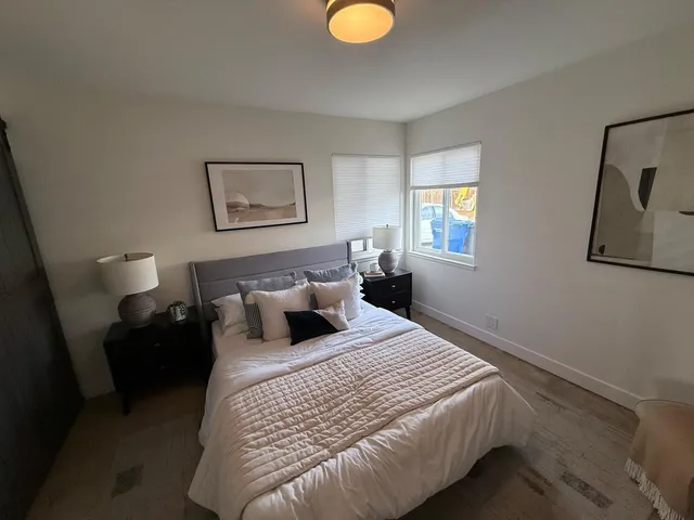 a bedroom with bed and window