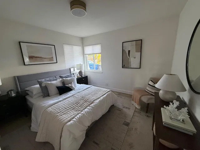 a bedroom with bed and a window